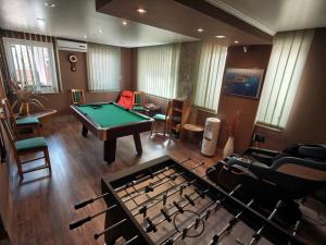 a living room with a pool table and a table at Bed & Breakfast Villa Adriana in Premantura