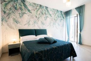 a bedroom with a bed with a wall mural at Villa Rossa in Agerola