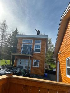 a house with a statue on the top of it at Cupids Guest House and SheShed in Brigus +4 photos