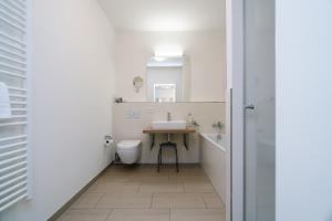 a bathroom with a sink and a toilet at Südkap B-07 in Pelzerhaken +57 photos