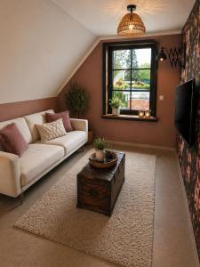 a living room with a couch and a coffee table at Vaerthof in Diepenbeek