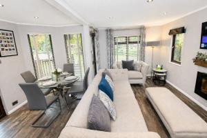 a living room with a couch and a table at Grasmere 12, White Cross Bay, Windermere in Troutbeck Bridge