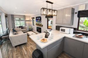 a kitchen and living room with a table and a counter at Grasmere 12, White Cross Bay, Windermere in Troutbeck Bridge