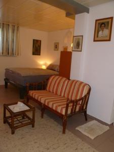 a living room with a couch and a bed at Villa XADAYU, Appartment in Reichenau +12 photos