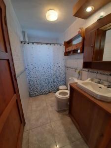 a bathroom with a toilet and a sink at Tongoy península in Coquimbo