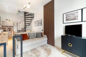 a living room with a couch and a tv at Dimora Camponobile - Turi in Turi
