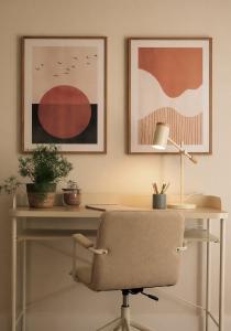 an office with a desk with a chair and posters at Pension Nagusia in Basauri