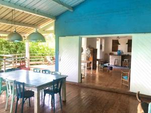a dining room and kitchen with a table and chairs at La villa bleue in Koungou