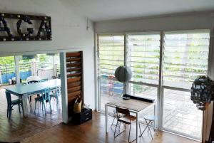 a dining room with a table and chairs in a room at La villa bleue in Koungou +12 photos