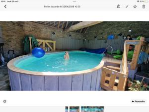a person in a swimming pool with a ball in it at La poésie de l'instant in Bétête