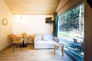 a living room with a couch and a table at La Playa Resort & Camp Trzebinia in Trzebinia