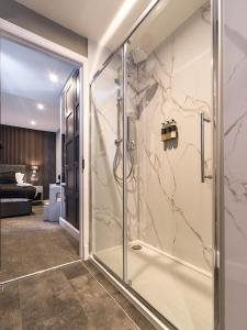 a bathroom with a shower with a glass door at Hotel 30 Five in Aberdeen