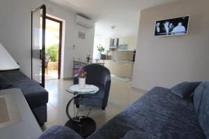 a living room with a couch and a table at V Apartment in Rabac