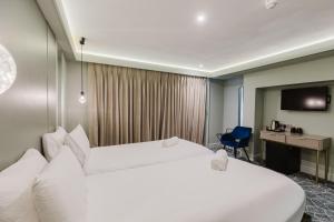 a hotel room with two beds and a desk at The Lancaster Hotel in London +203 photos