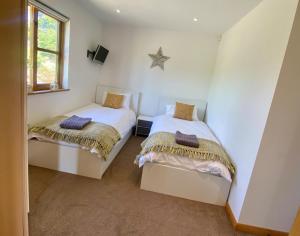 a bedroom with two beds and a star on the wall at Whitehall Farm in Caerleon