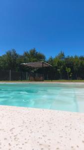 a beach with a gazebo in the background at Cabañas PxA in Villa Anizacate