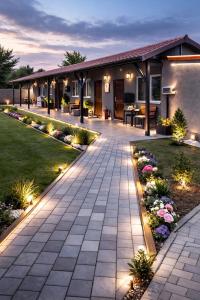 a patio with lights in the yard of a house at Pensiunea Ada in Balta Verde