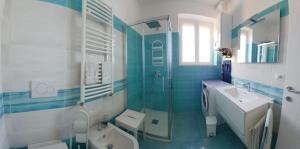 a blue and white bathroom with a sink and a shower at Venti In Costa in Furore +38 photos