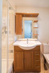 a bathroom with a sink and a shower at Sanctuary House in Thorpeness +63 photos