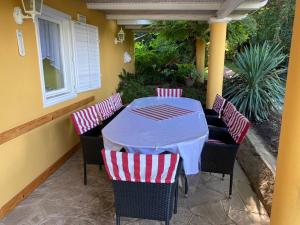 a table and chairs sitting on a porch with at La Dolche Villa in Szőlősgyörök