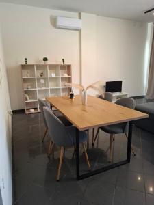 a dining room with a wooden table and chairs at KATHRIN APPARTS in Alepou