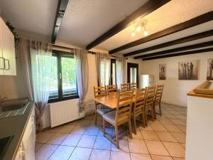 a kitchen and dining room with a table and chairs at Rose Cottage in Bovec