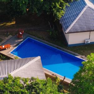 an overhead view of a swimming pool next to a house at Nature Luxe Sigiriya in Sigiriya