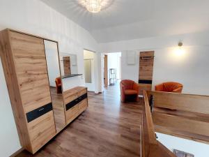 a living room with a large mirror and wooden doors at Pension Paßler in Seeboden