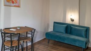 a couch and a table in a room at ISIDORA home in Rethymno