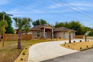 a house with palm trees and a driveway at 2 Mi to Beach! Group-Friendly Navarre Getaway in Navarre