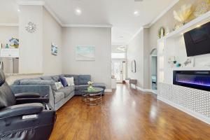 a living room with a couch and a tv at 2 Mi to Beach! Group-Friendly Navarre Getaway in Navarre