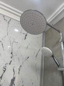 a shower head in a bathroom with a marble wall at Villa Island Zembra in El Haouaria +70 photos