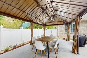 a patio with a wooden table and chairs at 2 Mi to Beach! Group-Friendly Navarre Getaway in Navarre
