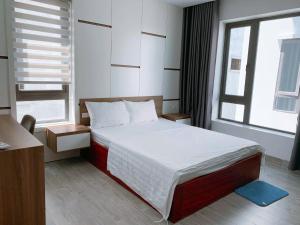 a small bedroom with a bed and a window at FLC Grand Villa BT31-26 in Sầm Sơn +16 photos
