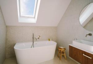 a bathroom with a tub and a sink and a mirror at Wolne Domy in Dominikowice +49 photos