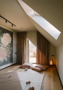 a bedroom with two beds and a large window at Wolne Domy in Dominikowice