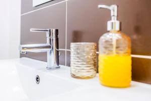 a bottle of soap sitting next to a sink at Casa Da Avo Clementina in Funchal +31 photos