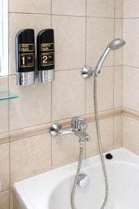a bathroom with a shower head and a sink at Máchova in Prague +75 photos