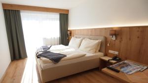 a bedroom with a large bed and a window at Hotel Sonnhof in Innsbruck +72 photos
