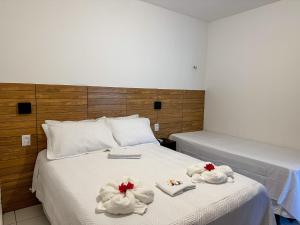 a bedroom with two towels on a bed at Pousada Villa Galinhos in Galinhos +29 photos