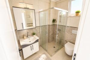 a bathroom with a shower and a sink and a toilet at Villa Maya in Ortaca +9 photos
