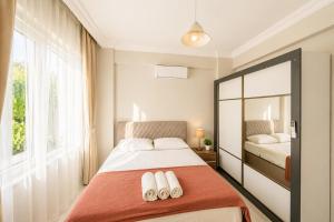 a bedroom with a bed with two towels on it at Villa Maya in Ortaca