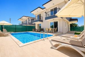 a villa with a swimming pool and a house at Villa Maya in Ortaca