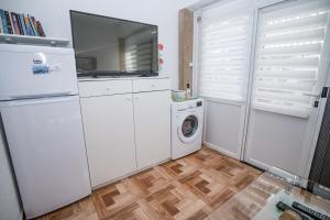 a kitchen with white appliances and a washer and dryer at MA-LO 1 in Pirovac