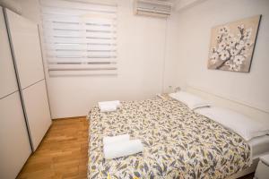 a bedroom with a bed in a white room at MA-LO 1 in Pirovac