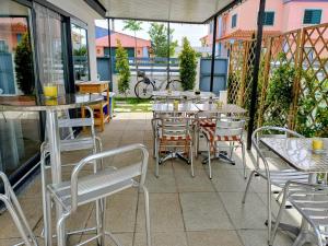 an outdoor patio with tables and chairs and windows at Relax & Travel in Almada