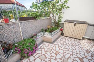 a garden with some flowers and a fence at MA-LO 1 in Pirovac