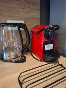 a red blender sitting on top of a table at KATHRIN APPARTS in Alepou