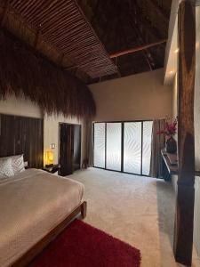 a bedroom with a large bed and a large window at Apartamentos "Ala Residencias" in Chetumal +136 photos