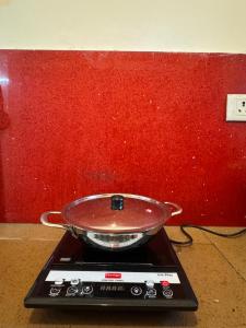 a pan sitting on top of a stove at Gachi Ghar Gachibowli 2 BHK in Hyderabad +2 photos